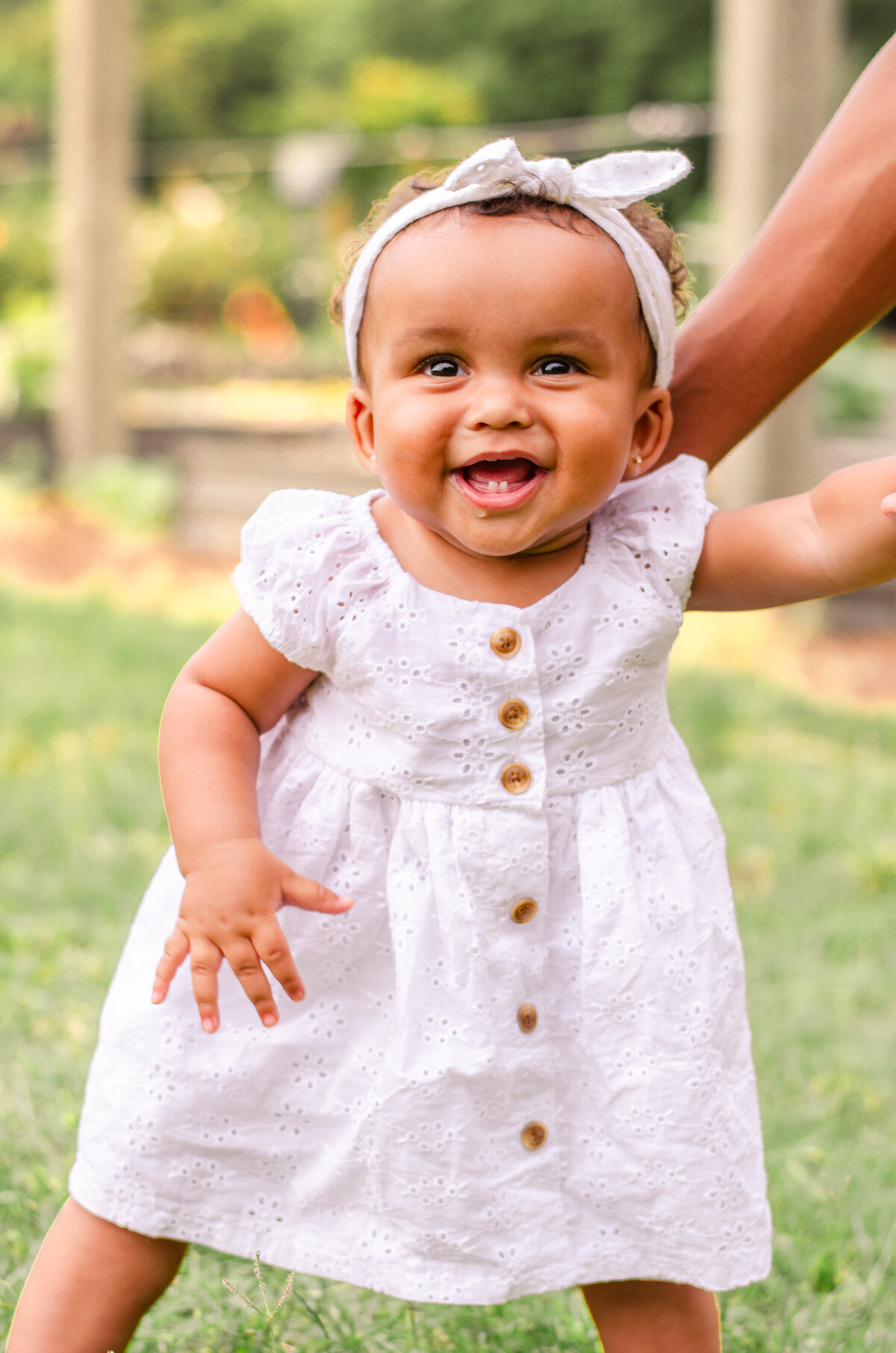 nine month old baby girl laughs