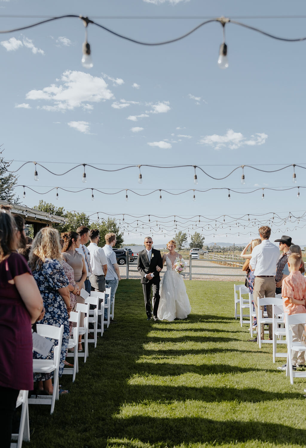 Couple walking up the outdoor aisle under market lights