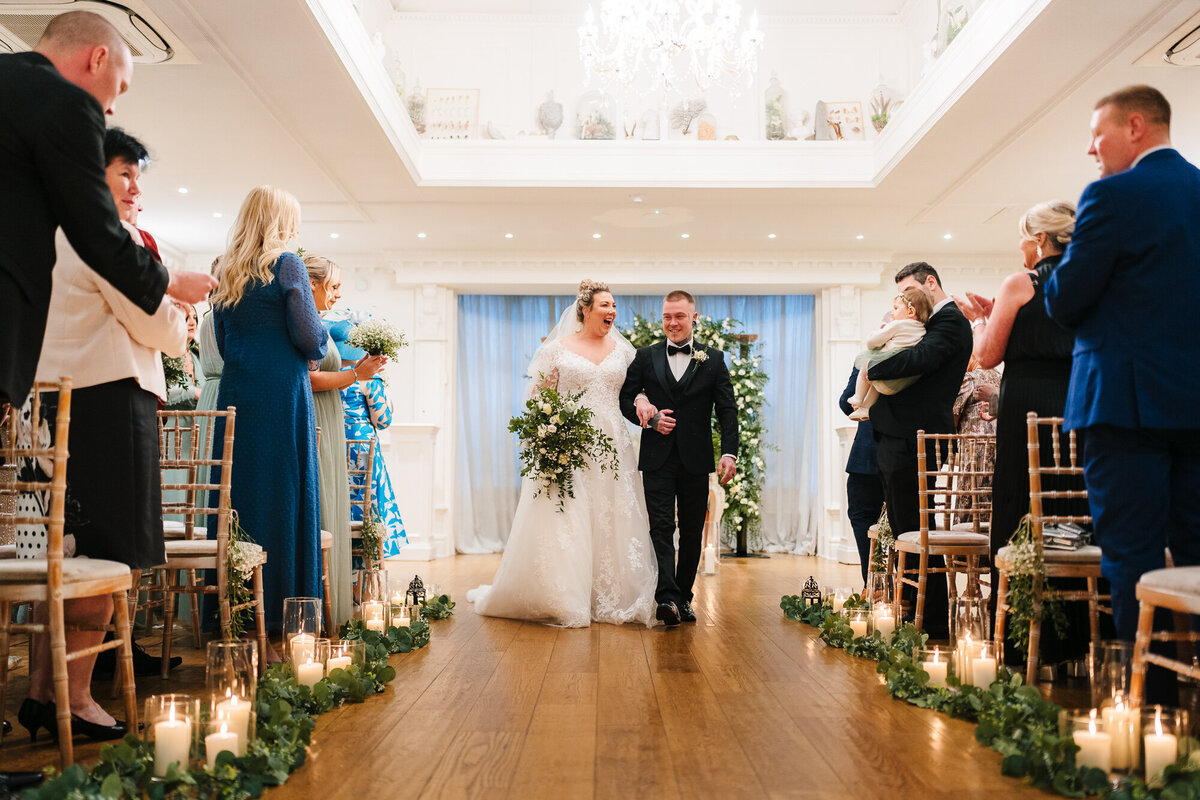 Bride and groom ewalking back down the aisle taken Ashfield House by Anthony Hosreman wedding photographer