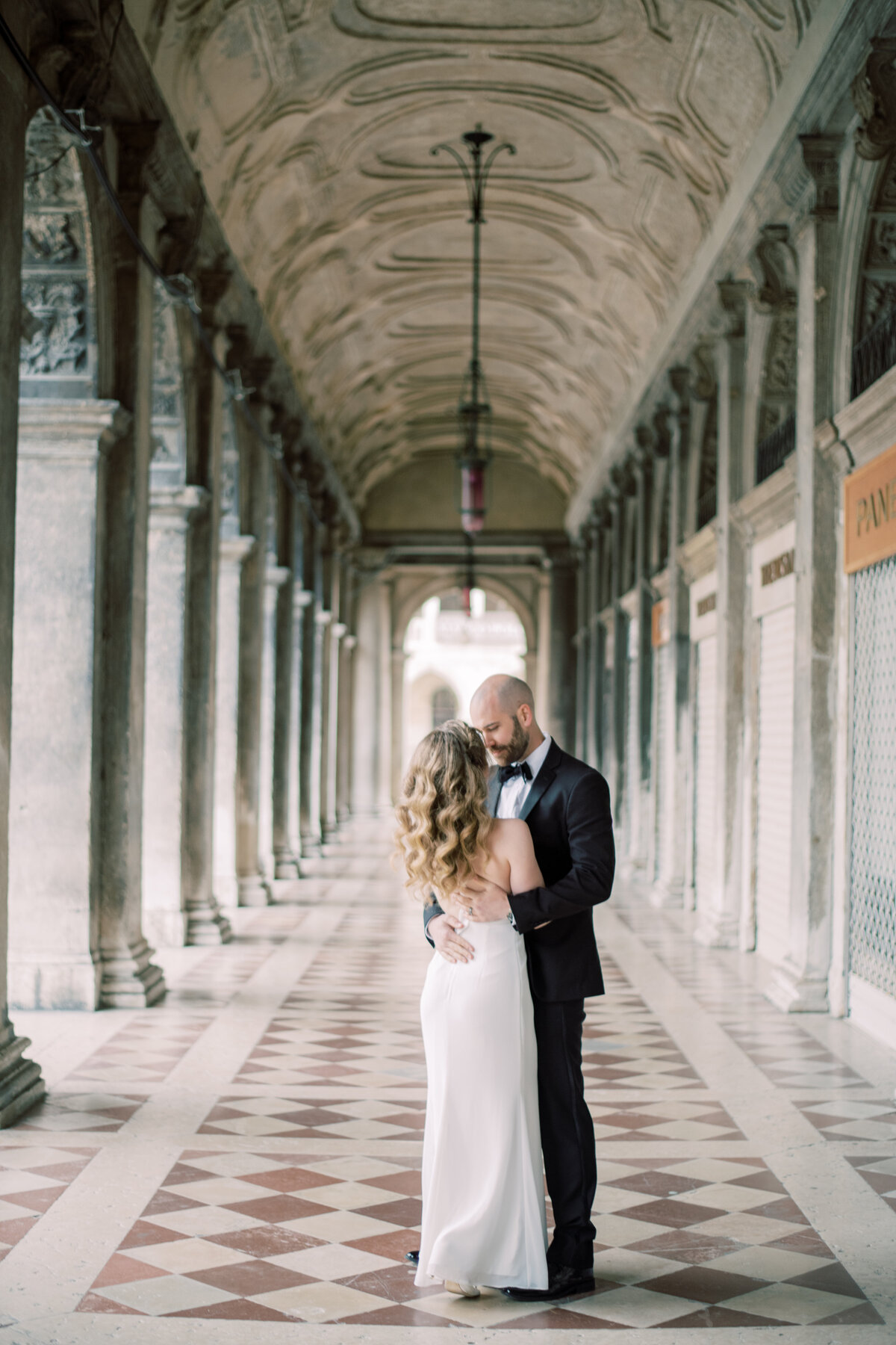 couple in Venice Italy, Man pulls woman in for a kiss romantically