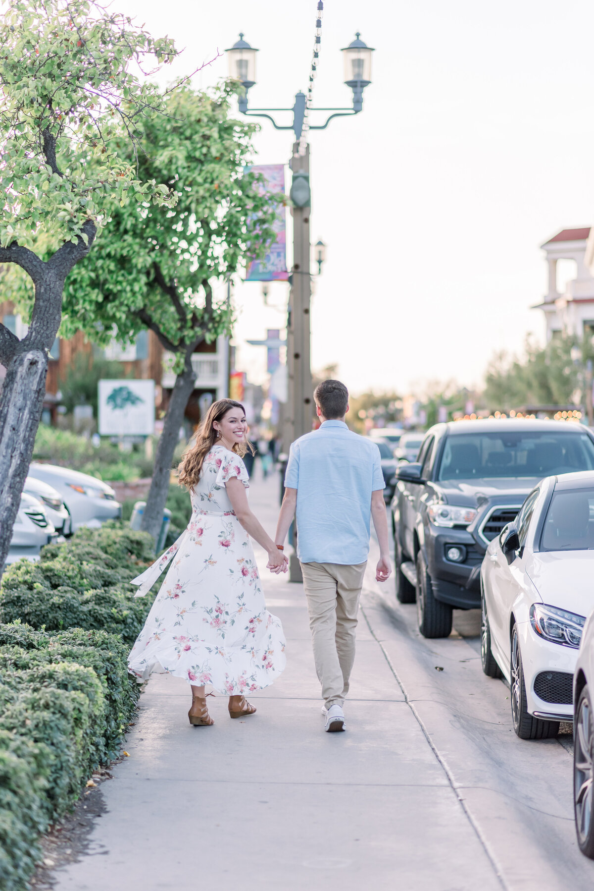 Couple walking in the streets of Temecula. Girl looking over the shoulder.