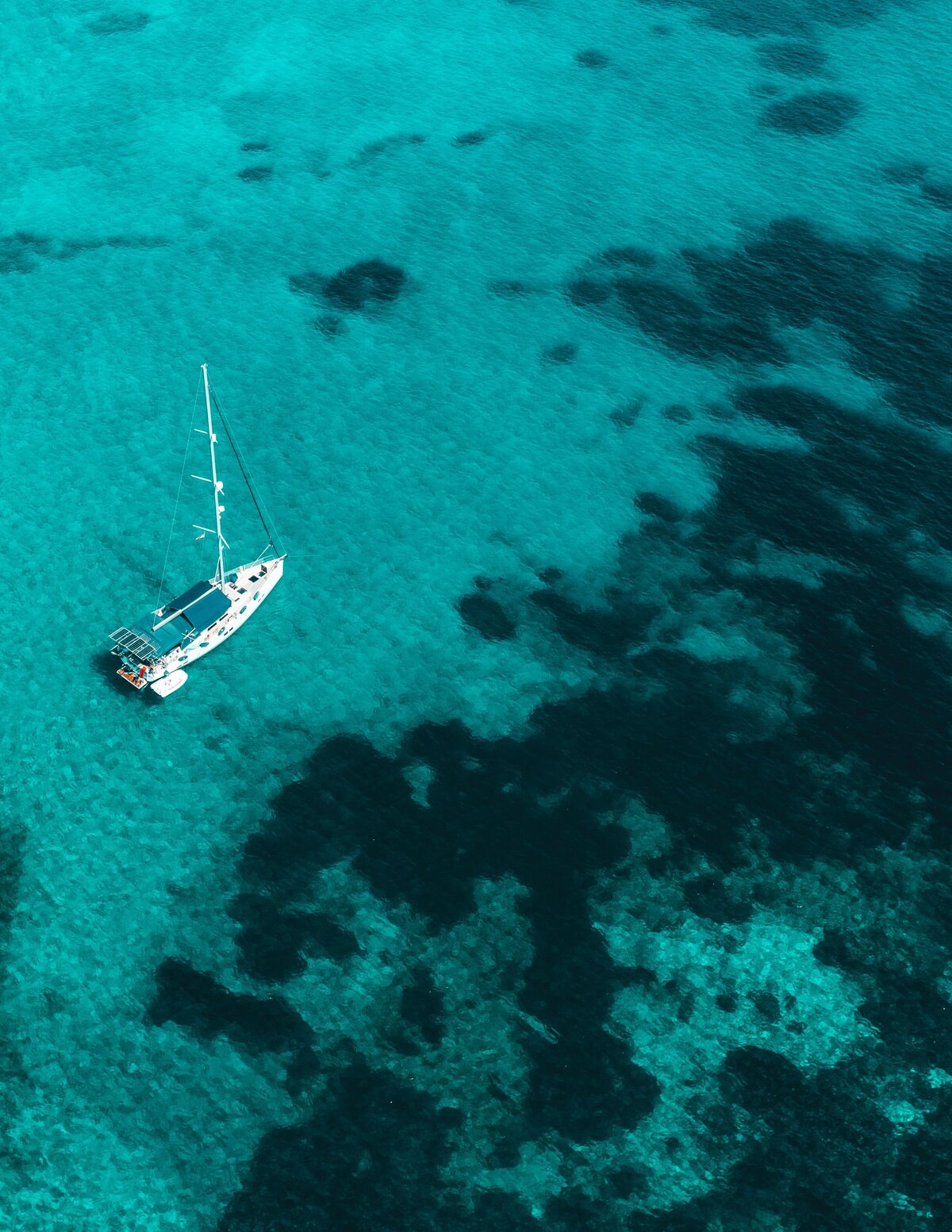 arial view of yacht in clear blue water in Blue Lagoon beach, Greece. 