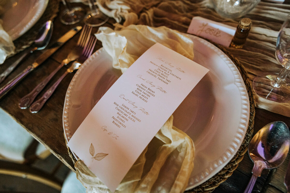 A table set with a menu and silverware