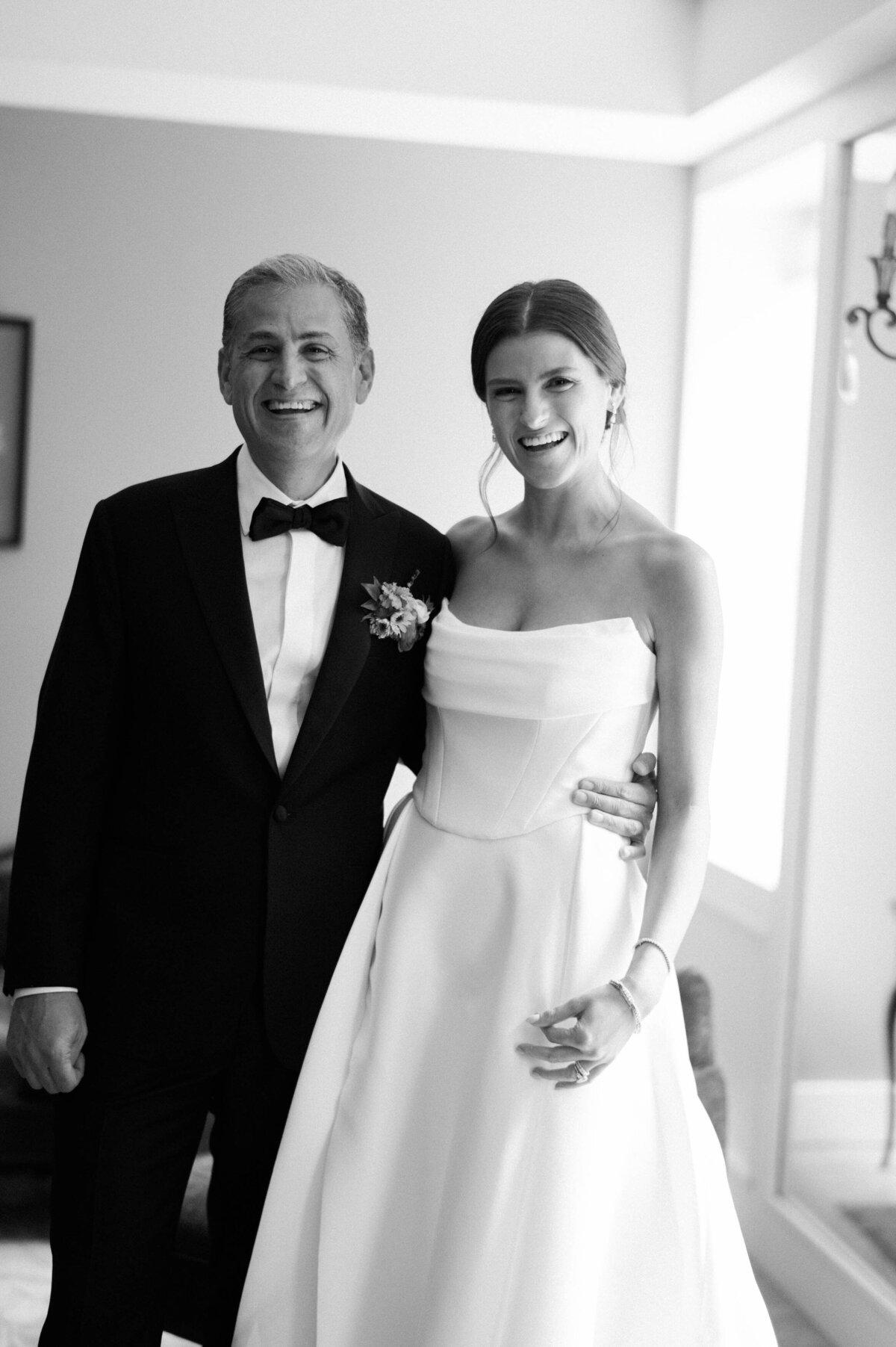 The bride smiles with her father