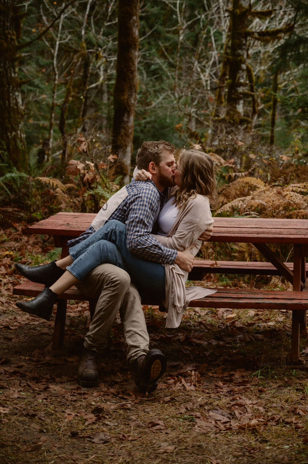 couple kissing on picnic bench in port alberni