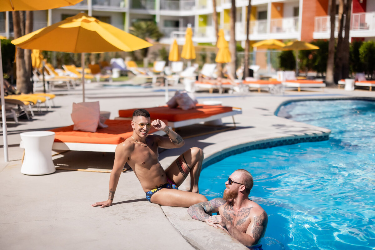 Editorial couple moment at the edge of a luxury Palm Springs pool, styled with bold swimwear and sunlit flair.