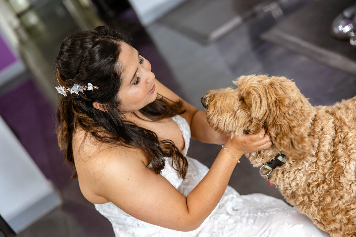 bride cuddles goldendoodle dog before San Antonio  wedding