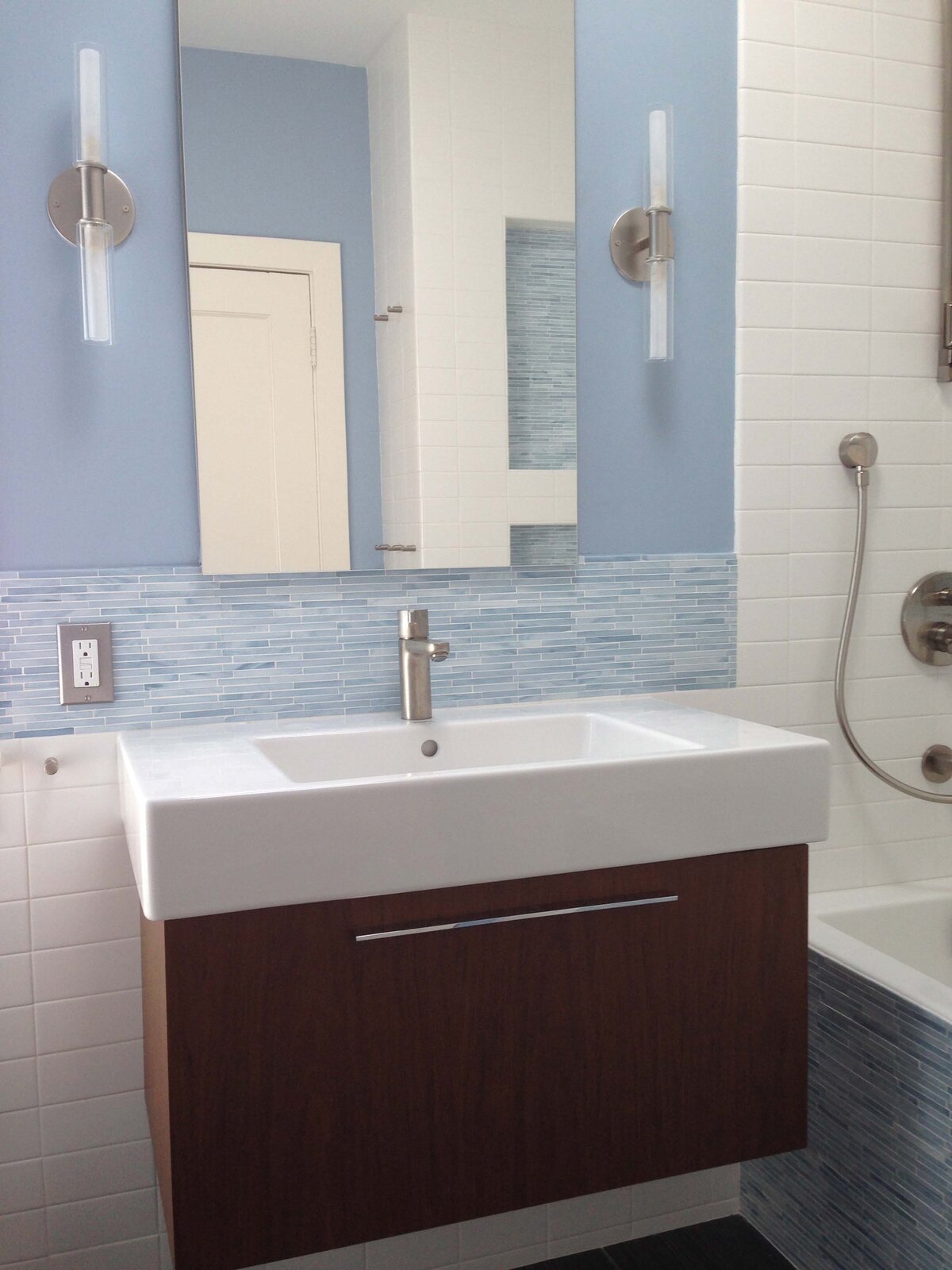 Bright bathroom renovation with light blue tilework