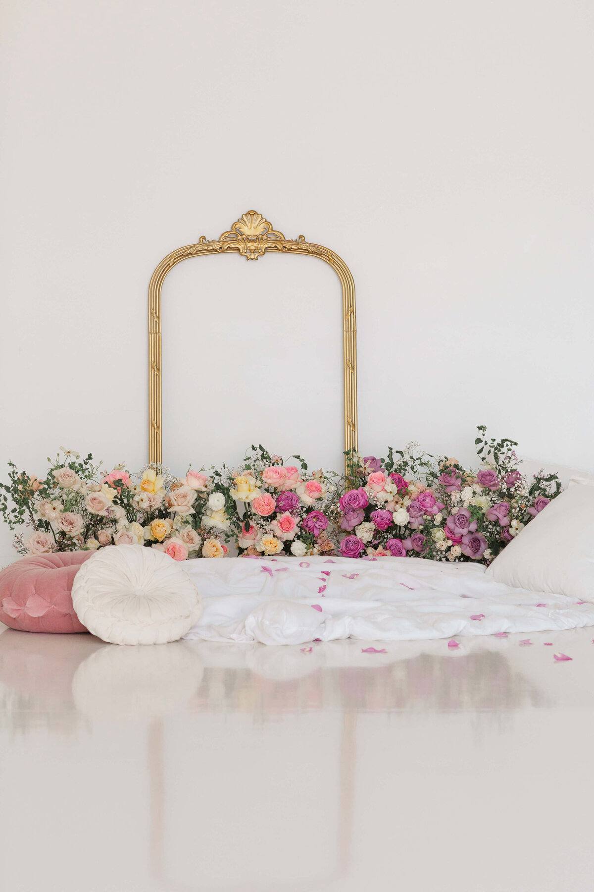 ornate mirror with pink, blush and purple florals in front