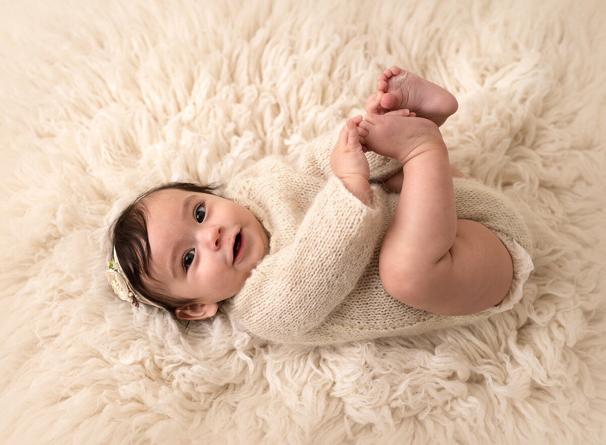 Adorable baby photo in cream colored furry background