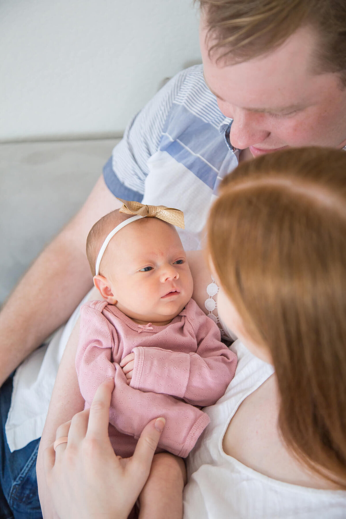 newborn baby girl looking at parents during las vegas newborn photography session