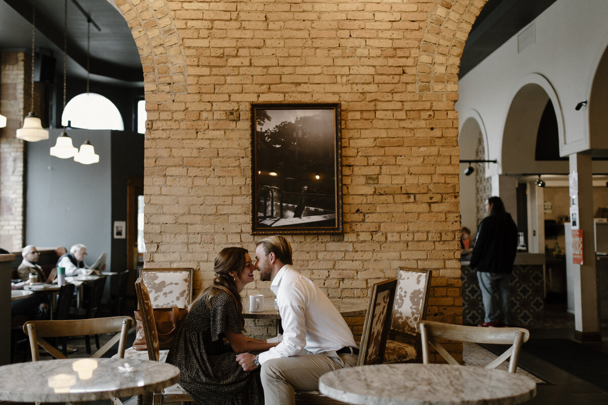 a man and woman about to kiss in a restaurant