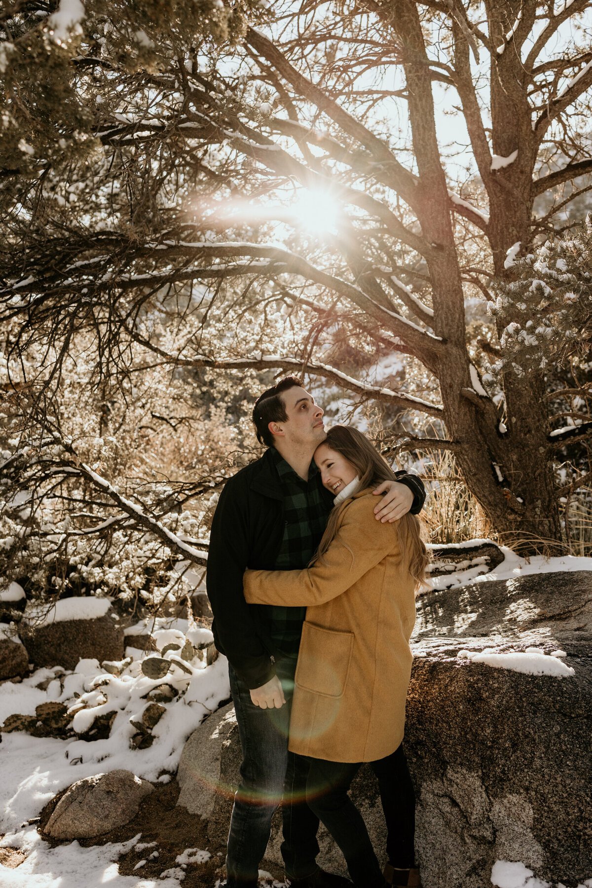 couple holding each other on a snowy mountain