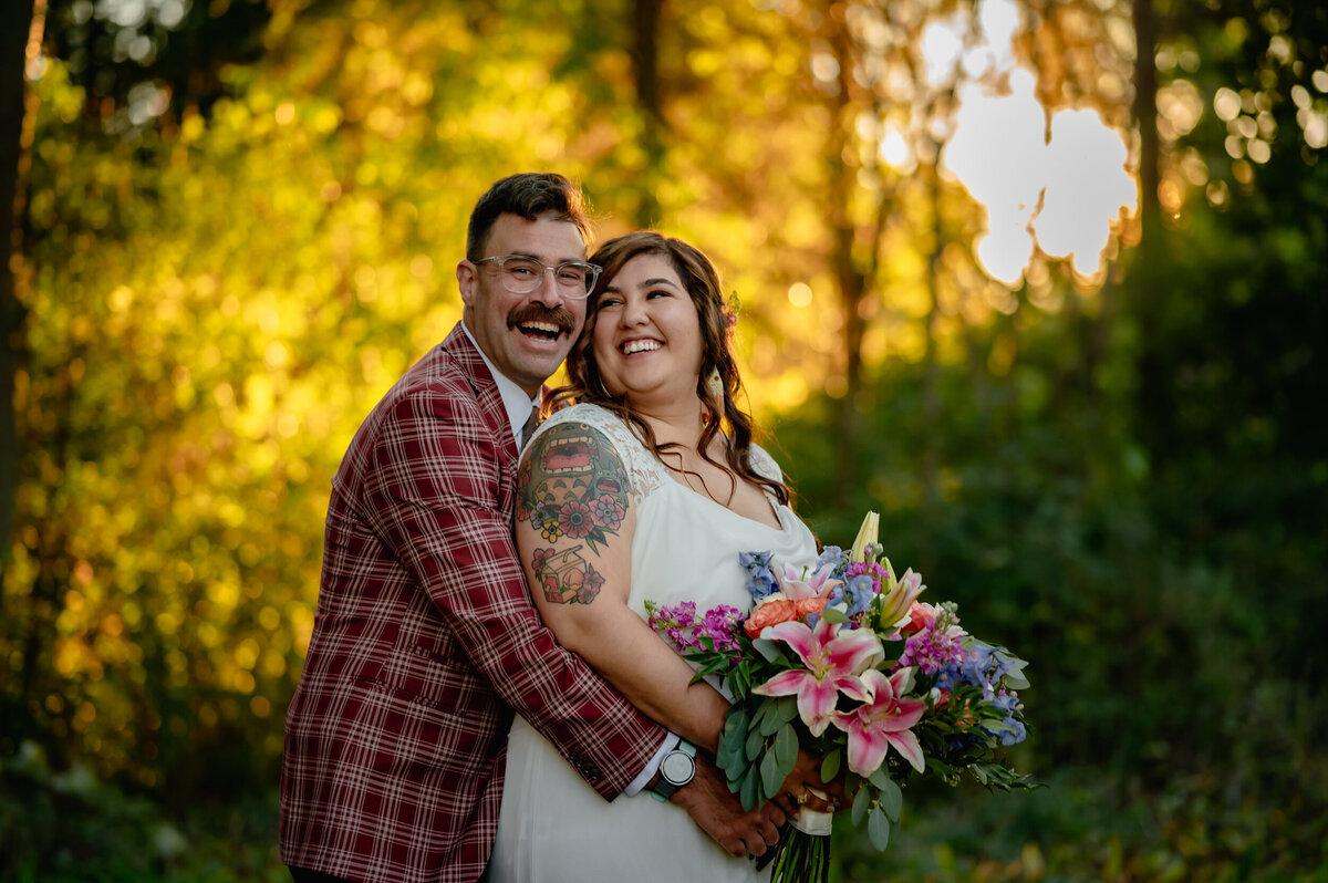 Groom wears a plaid suit during his backyard fall wedding