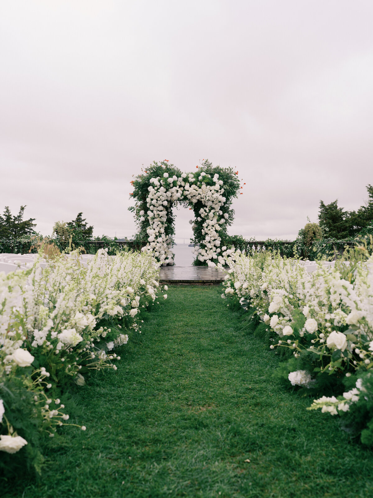 white-floral-wedding-arch-at-castle-hill-inn