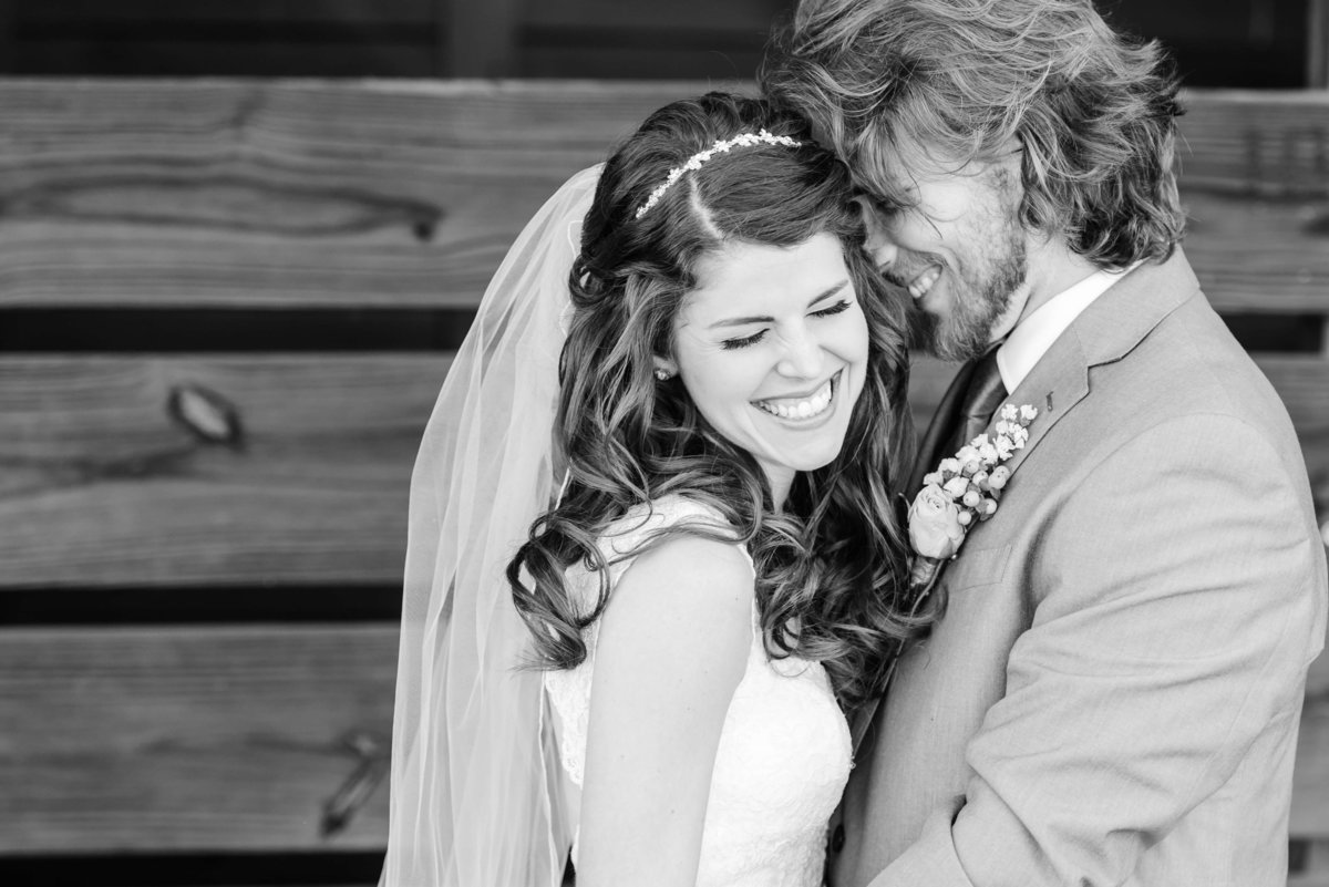 Bride and Groom share a laugh during their first look outside of a barn in Tampa, FL