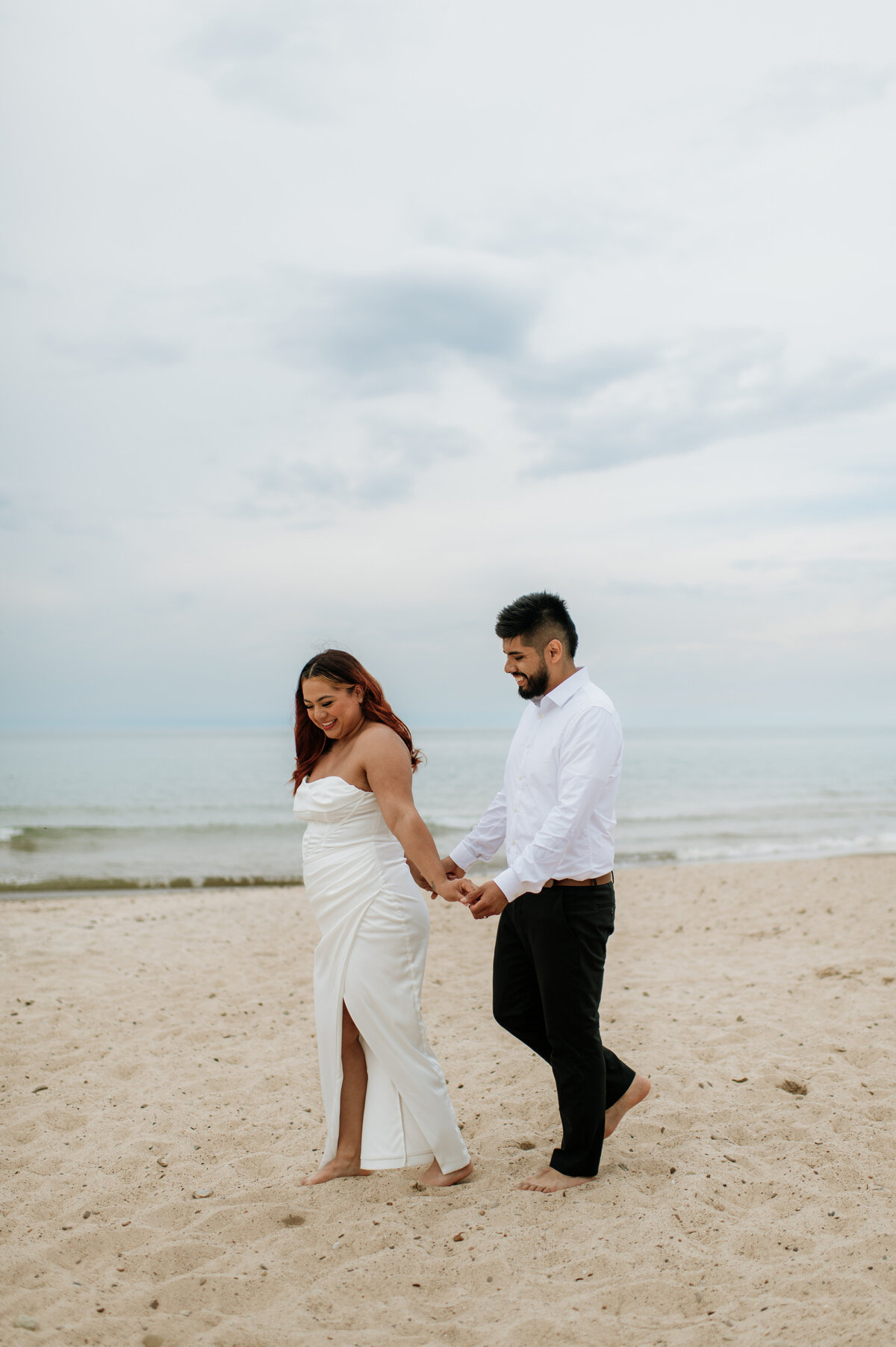 Bride and groom walking on South Bend beach