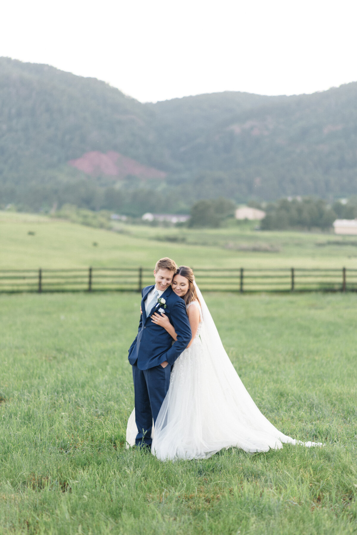Summer dusty blue wedding at Spruce Mountain Ranch, Larkspur, Colorado. Bride & groom sunset portraits.