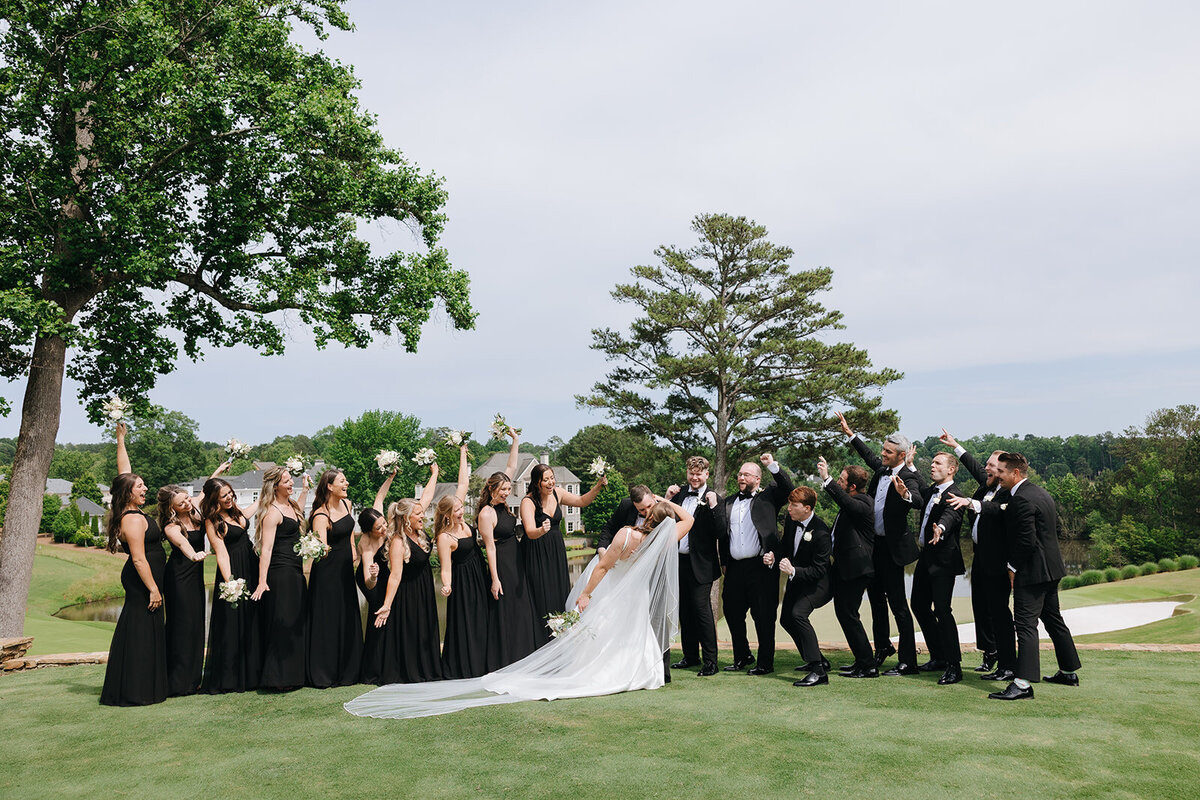 Wedding Party cheering bride and groom at TPC Sugarloaf in Duluth, Georgia.