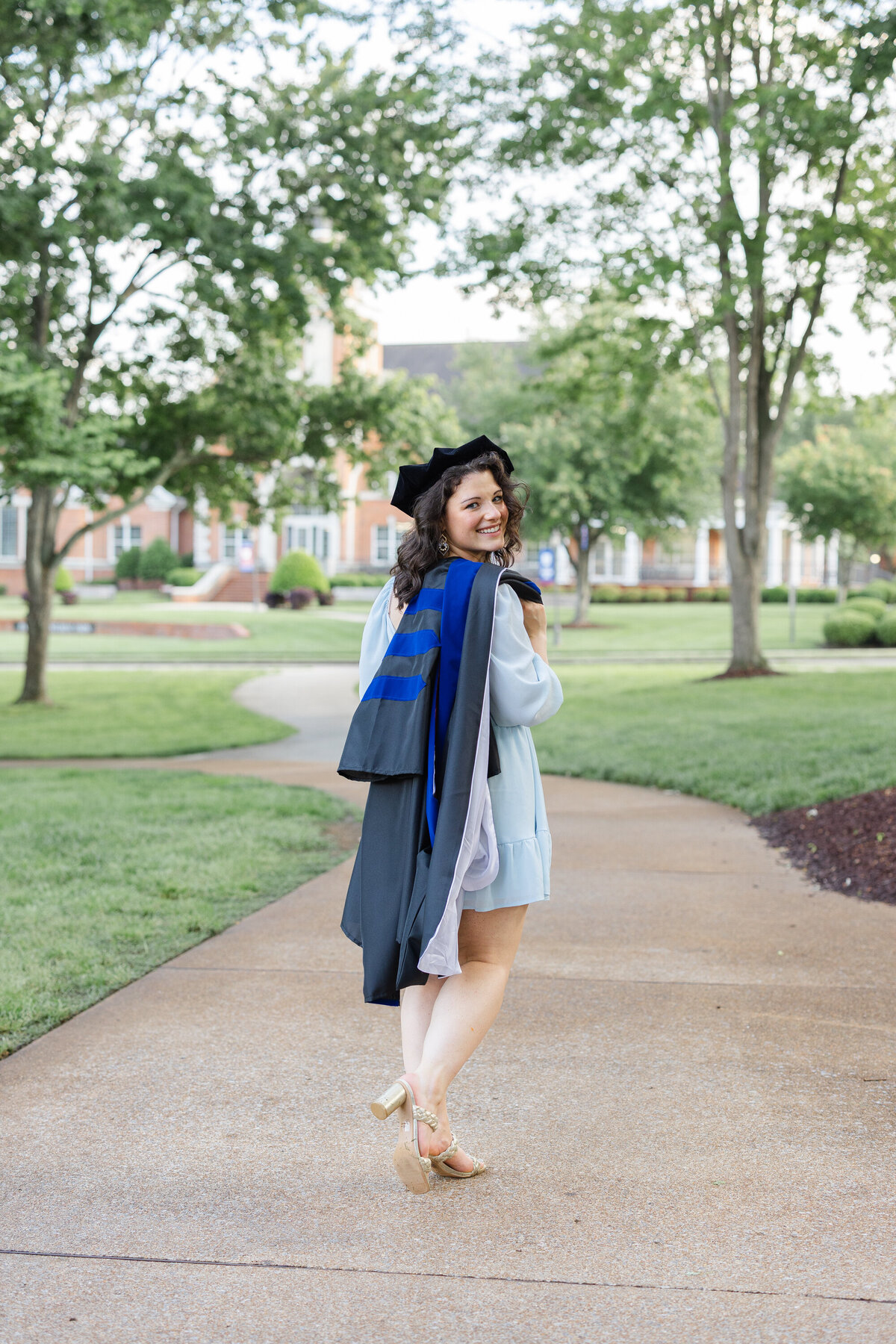 Lee University college senior posing with her cap and gown