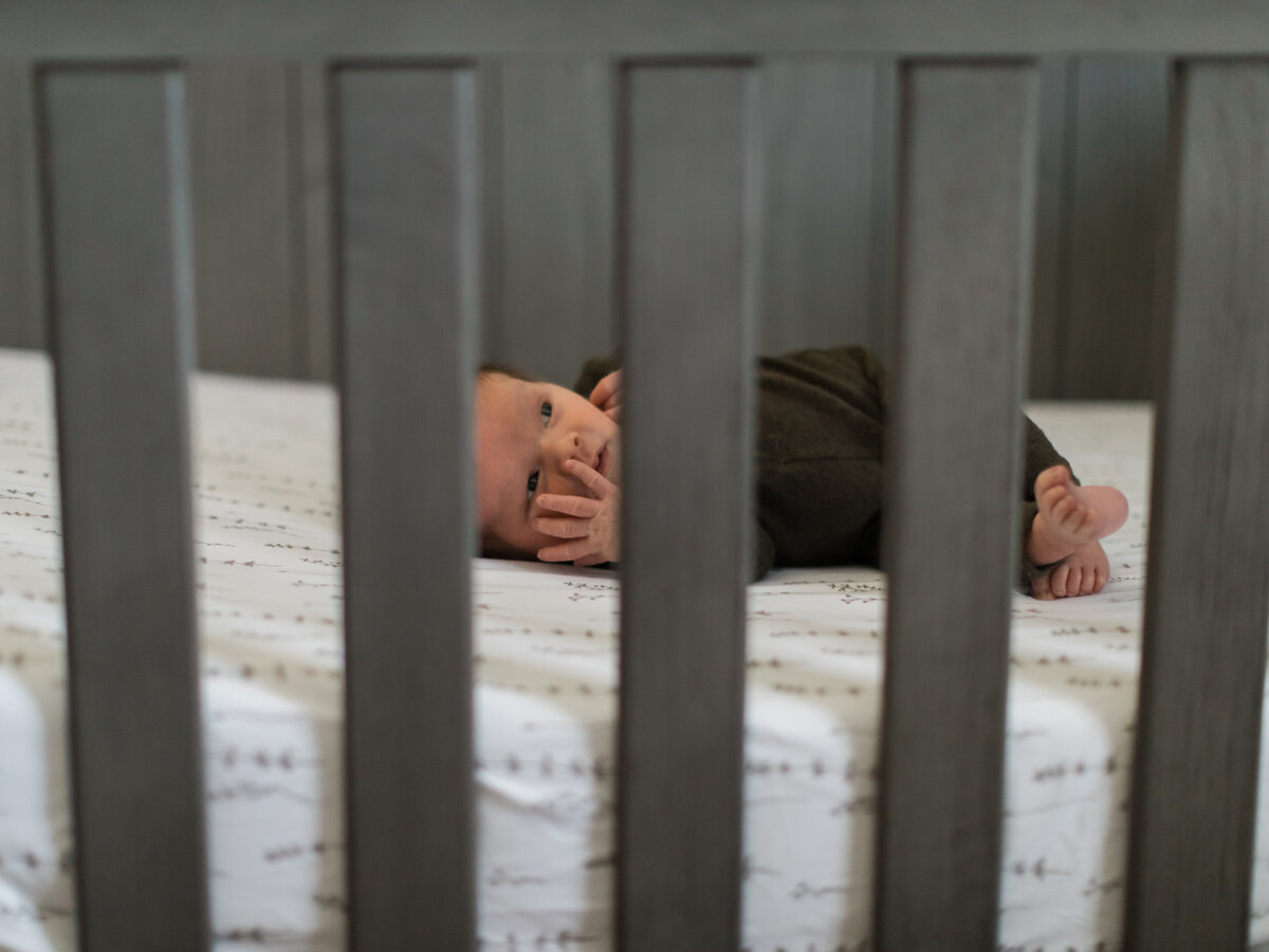 newborn baby boy laying in crib