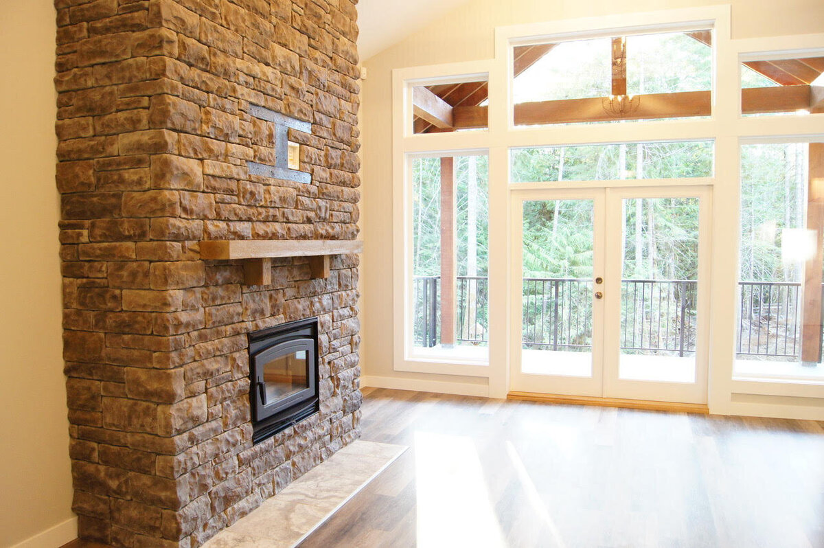 Stone floor to ceiling fireplace design.