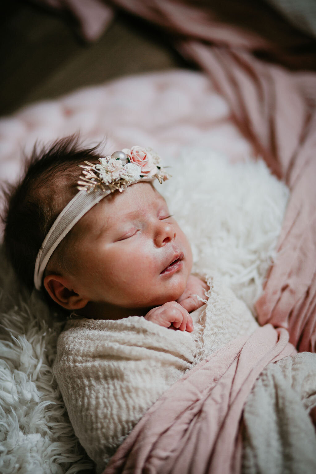 A newborn with a beautiful headband