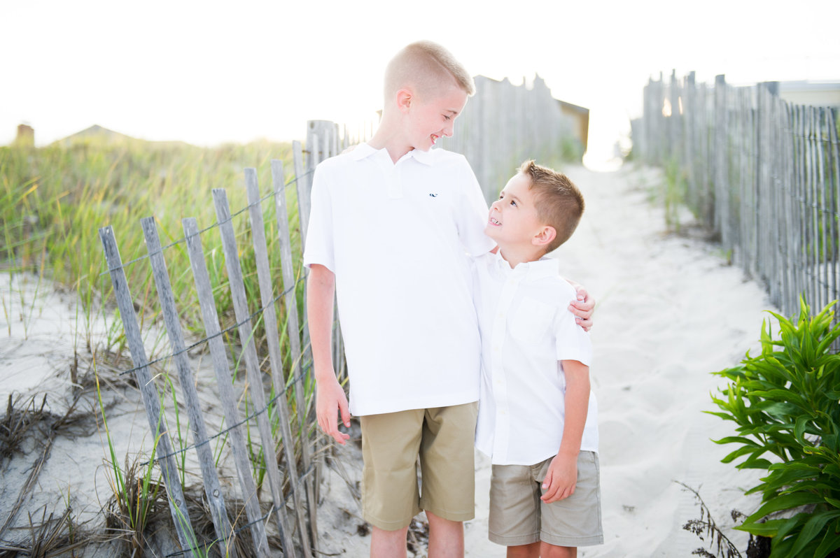 two boys with beach walk behind the,