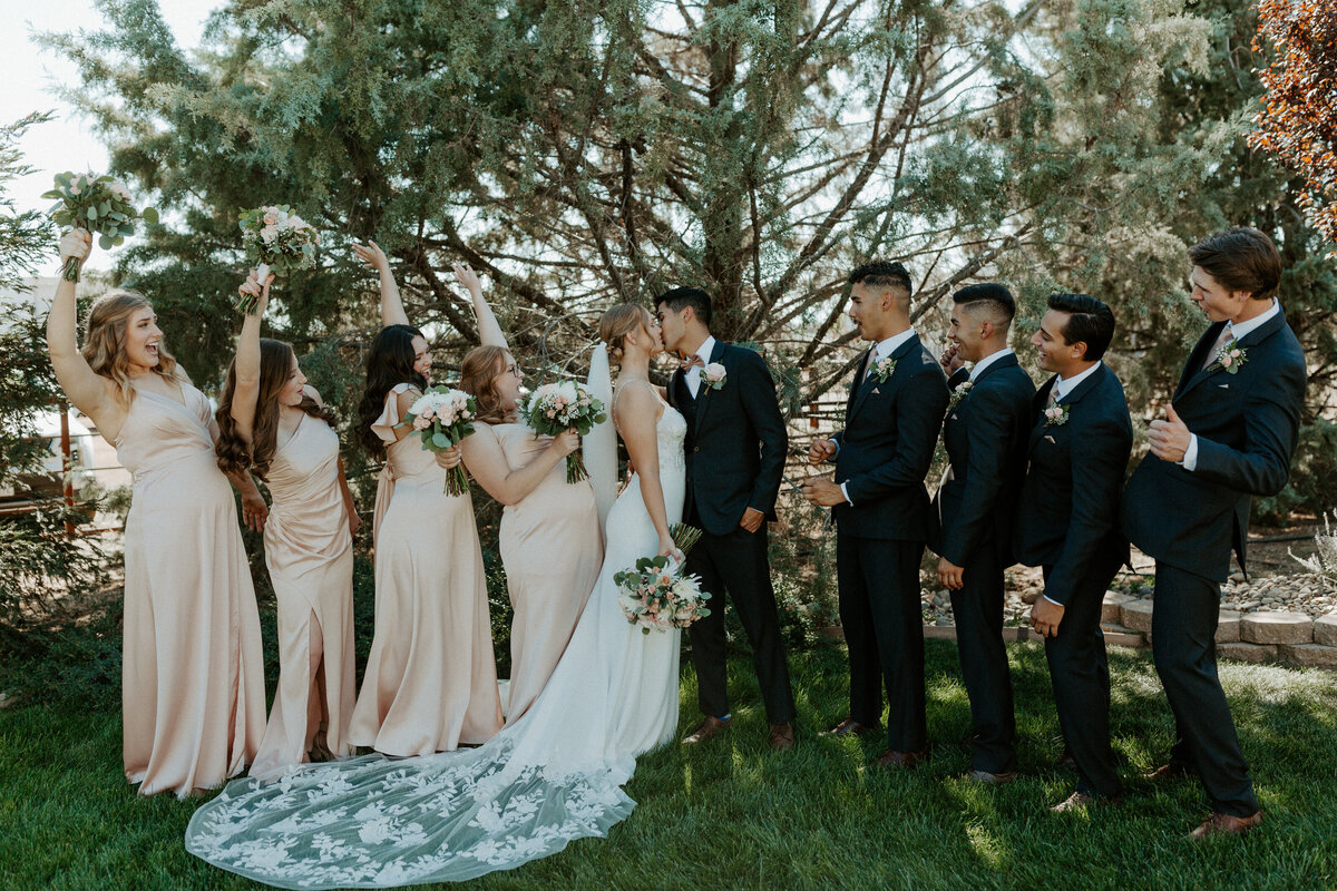 Entire Bridal Party Celebrating Bride and Groom