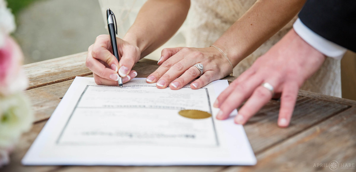 Signing marriage license after wedding ceremony in Denver Colorado