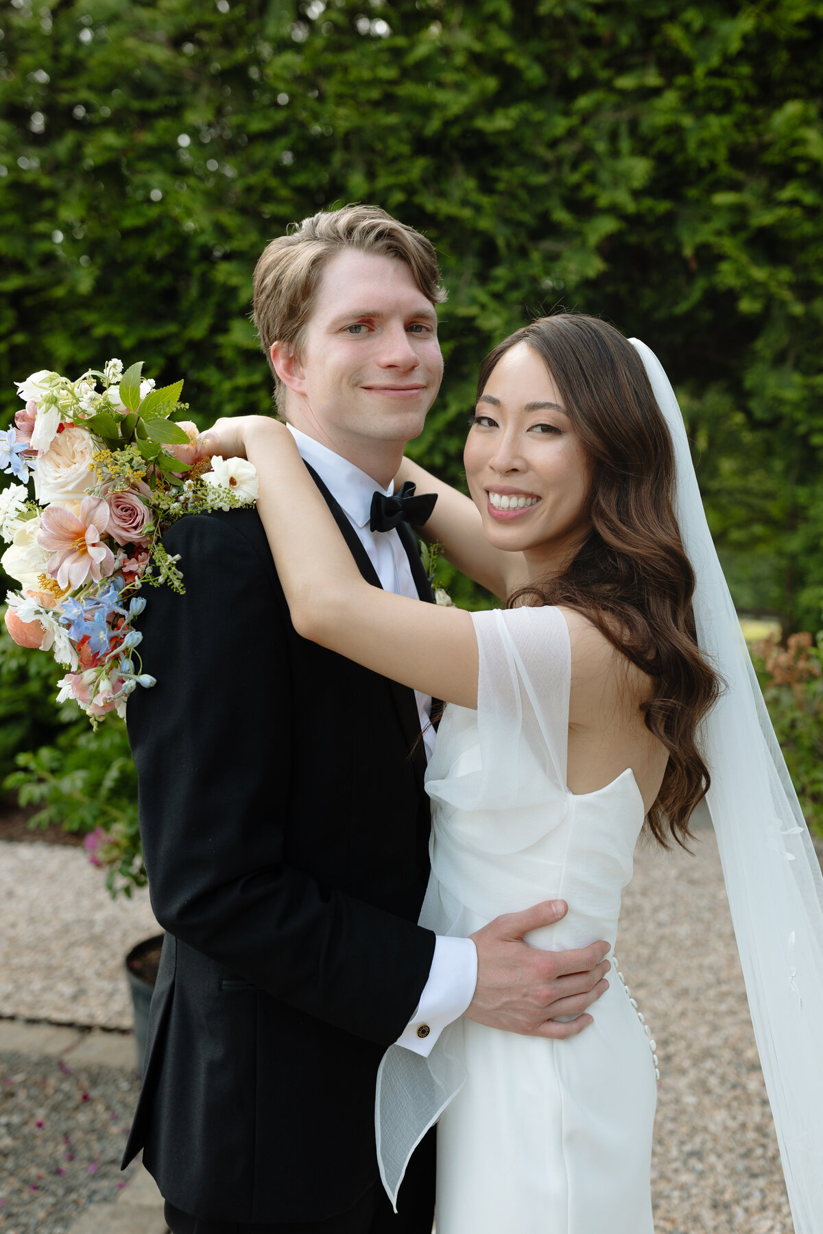Wedding couple posing for photos at the Market at Grelen. 