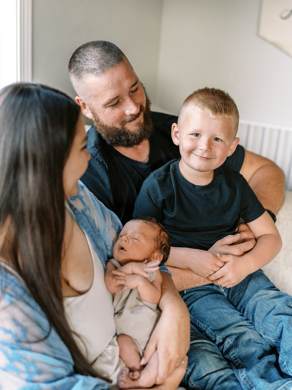 A family sitting together in their home during a family photography session.