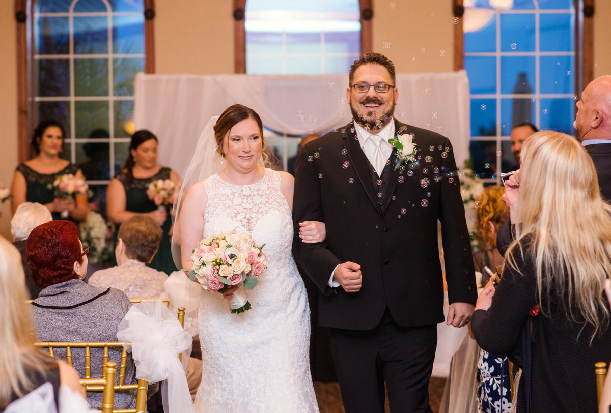 just married bride and groom walking down the aisle after wedding ceremony at Willow Creek Golf and Country Club