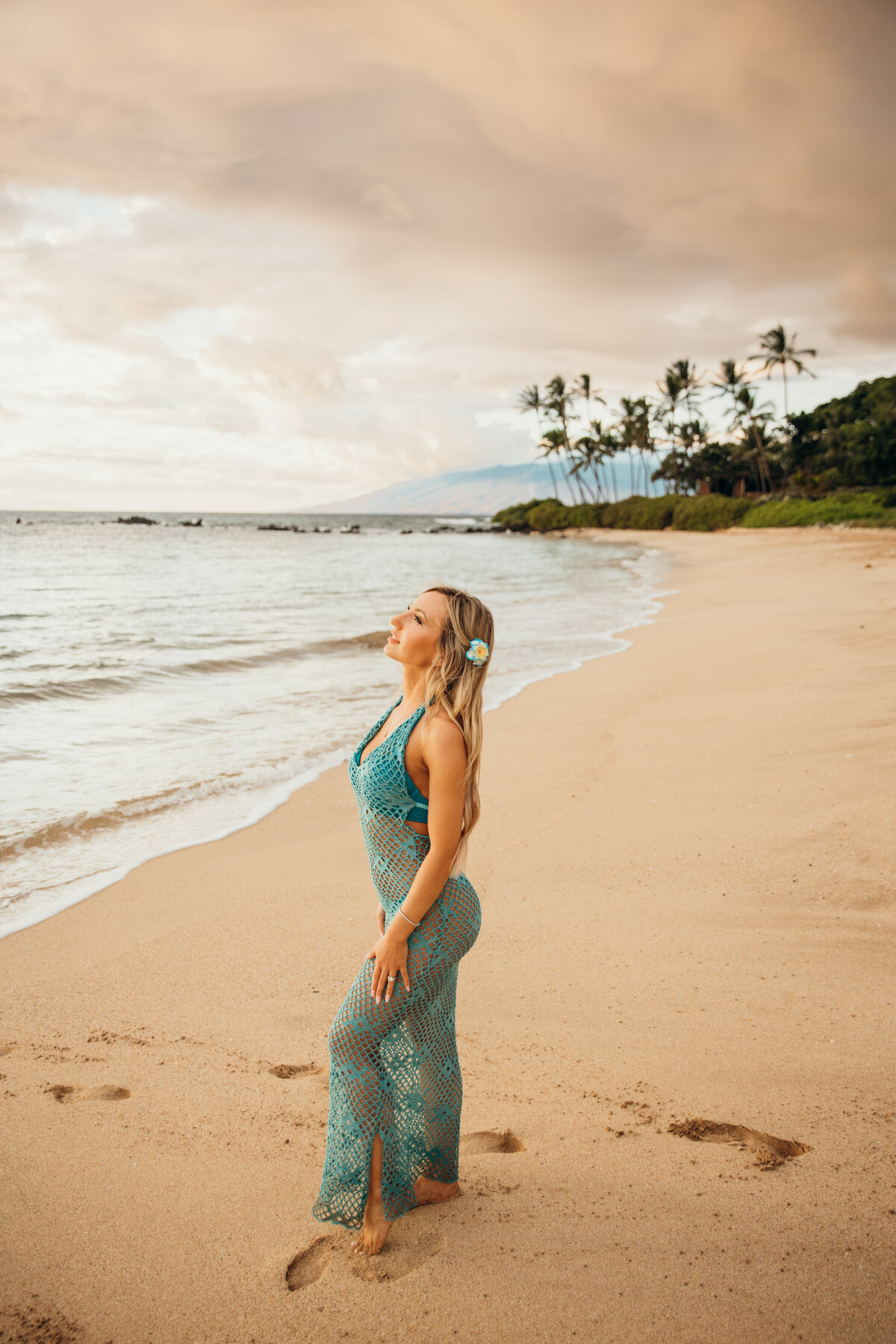 Hawaii Engagement Photographer captures woman posing on beach wearing teal dress