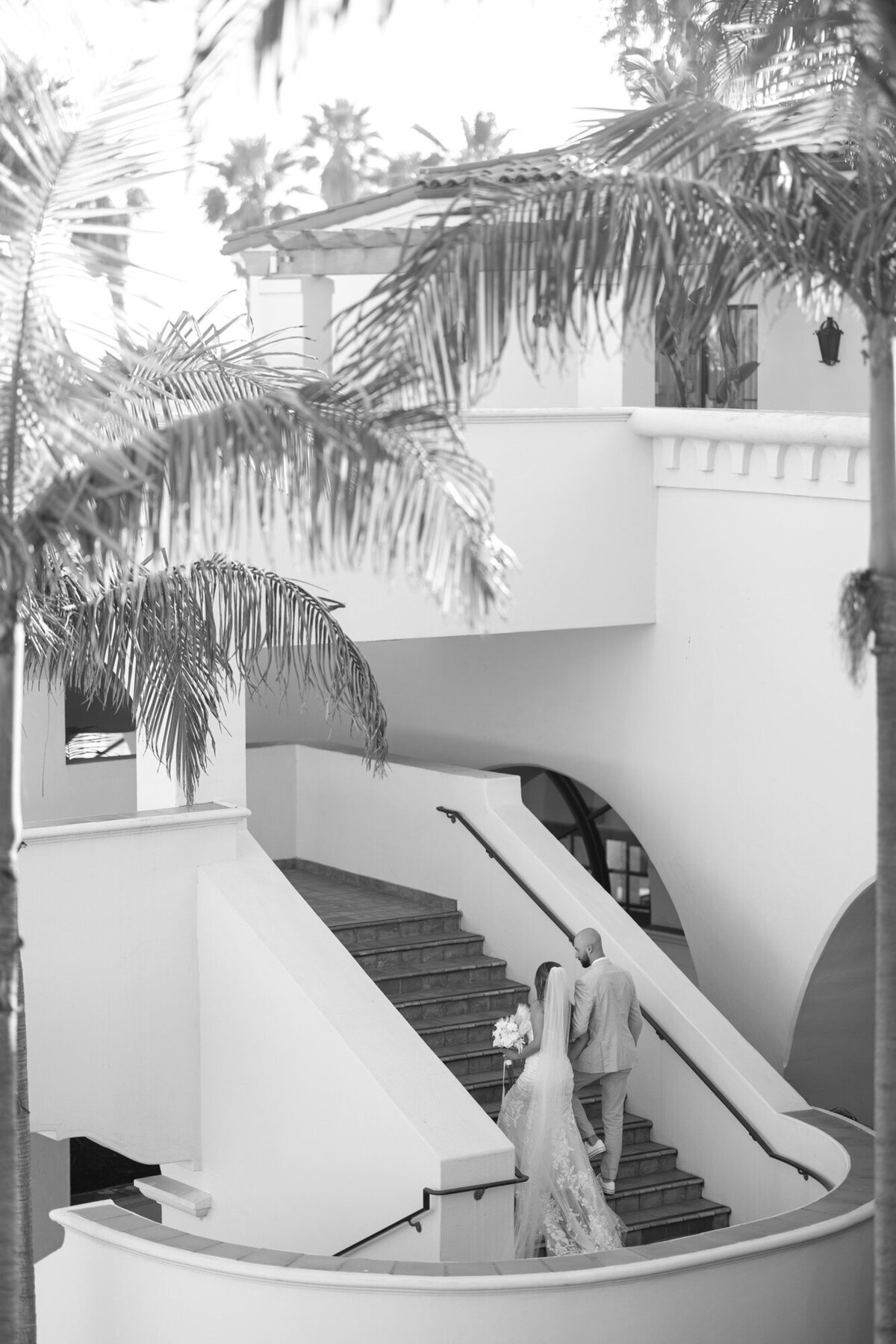 Bride and groom walking up steps at Hilton Beachfront Resort Santa Barbara
