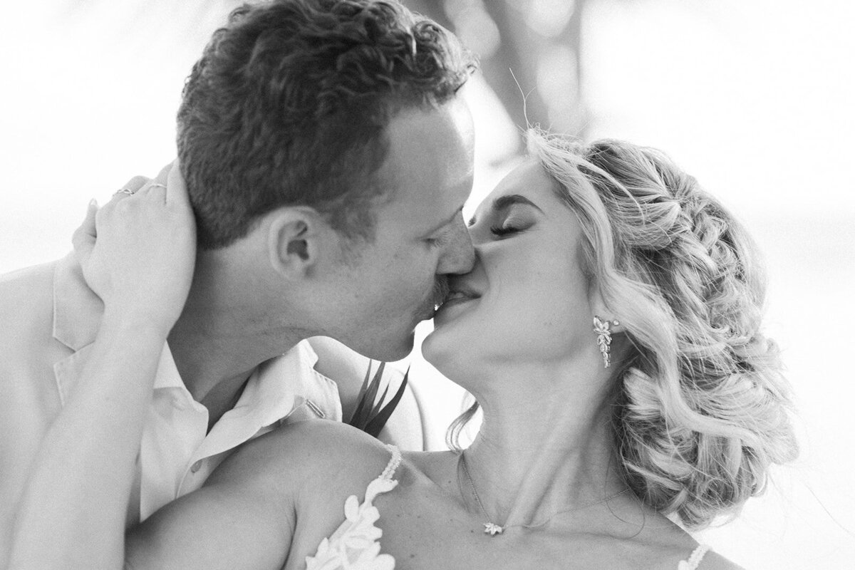 A romantic black-and-white close-up of Ashley and Hunter kissing