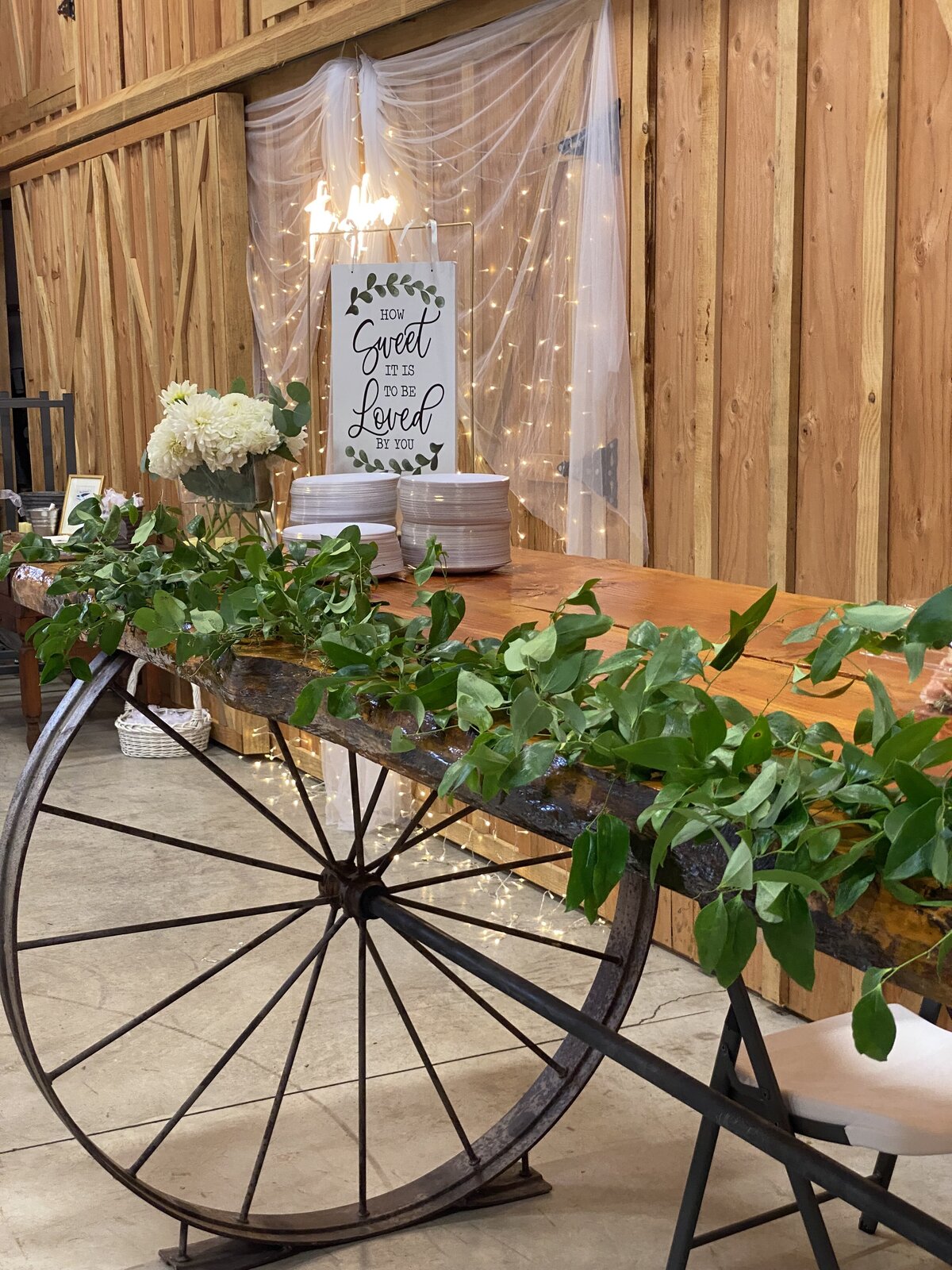 Smilax vine on the wood table with wagon wheels.