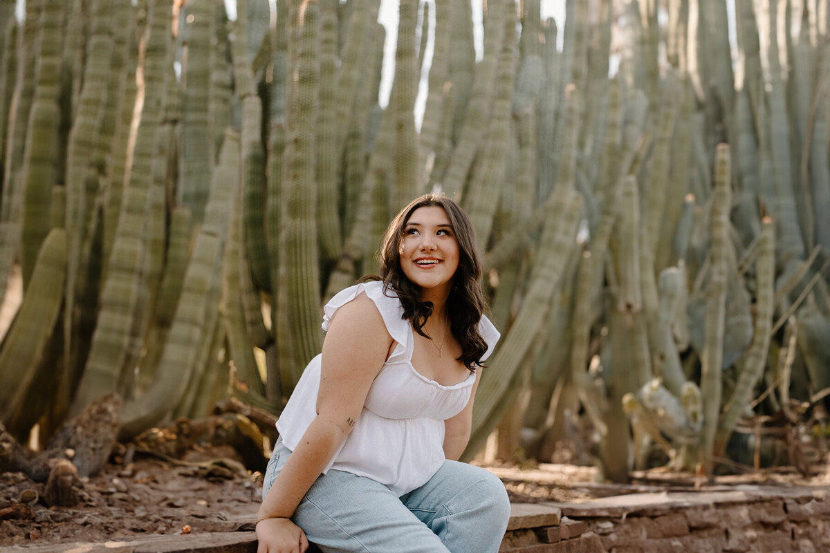 Senior sitting near cactus looking away at the Botanical Gardens