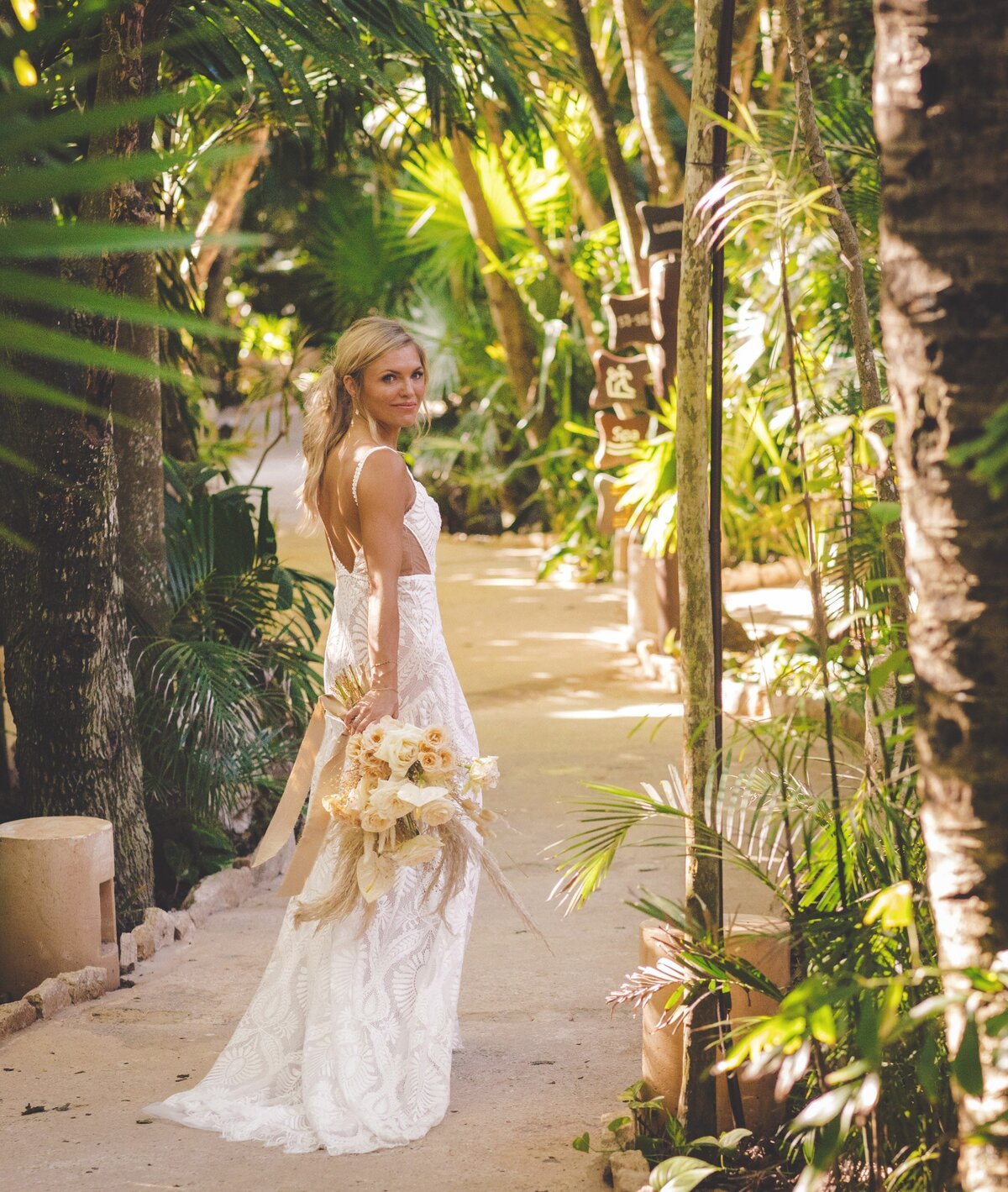 Bride walking on path at viceroy riviera maya wedding