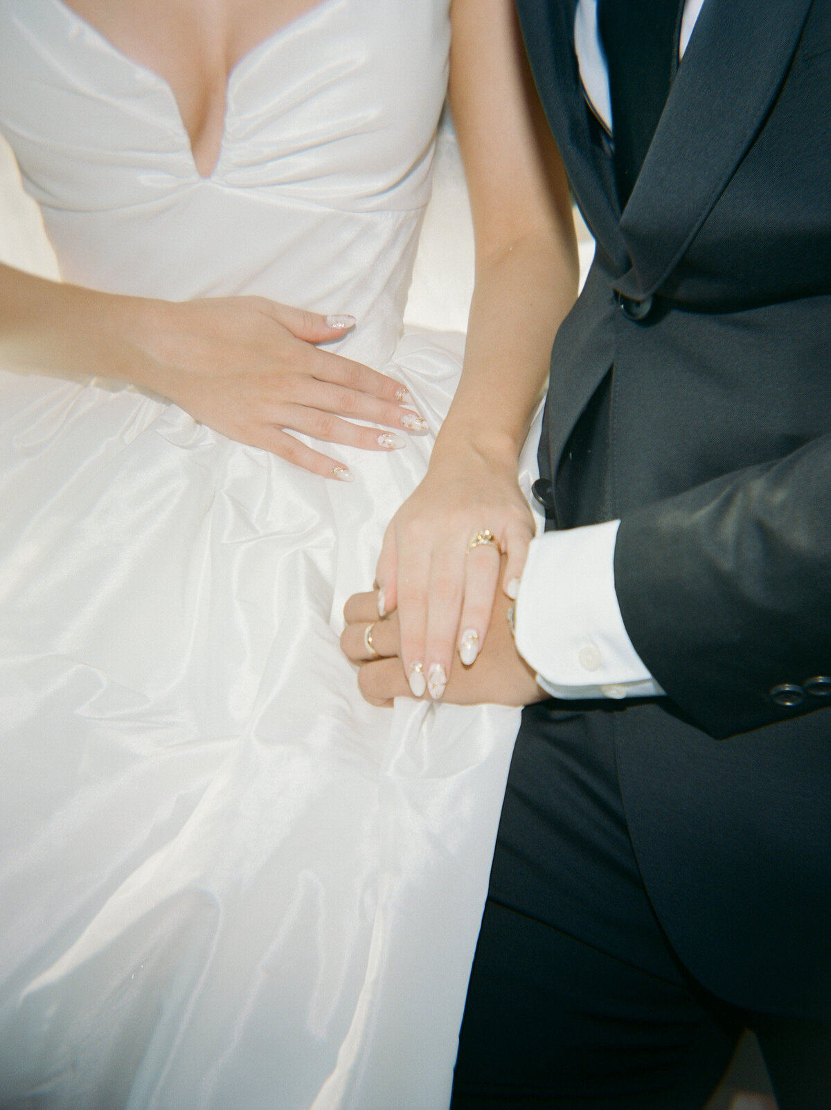 soft film photography, candid wedding photography in Detroit of a newlywed couple's ringed hands
