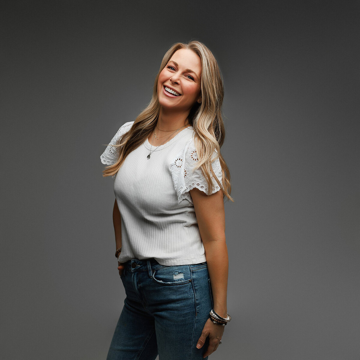 Elegant headshot of professional woman wearing tailored outfit, photographed by Austin headshot specialist