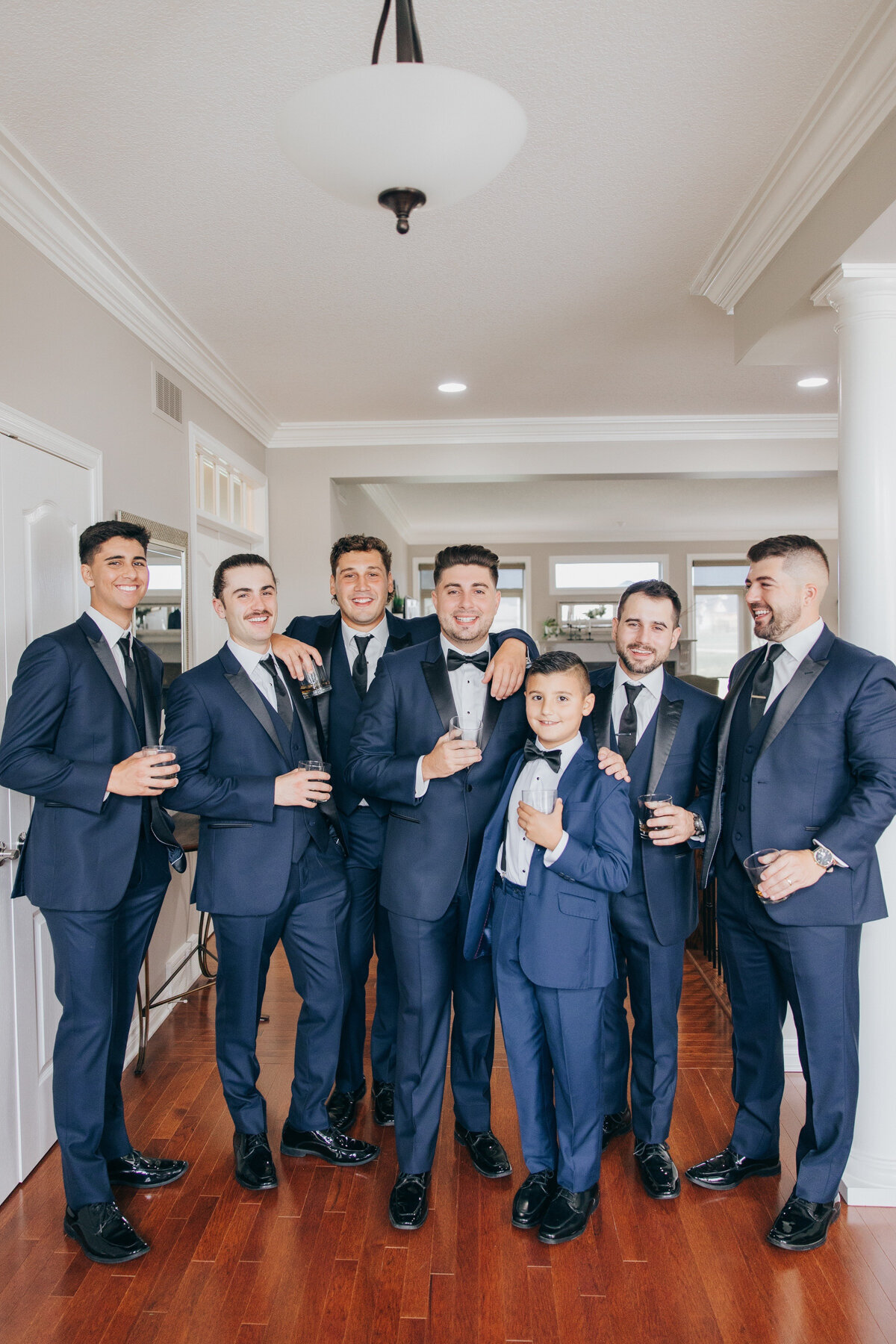 Groom and groomsmen sharing a toast on the wedding day