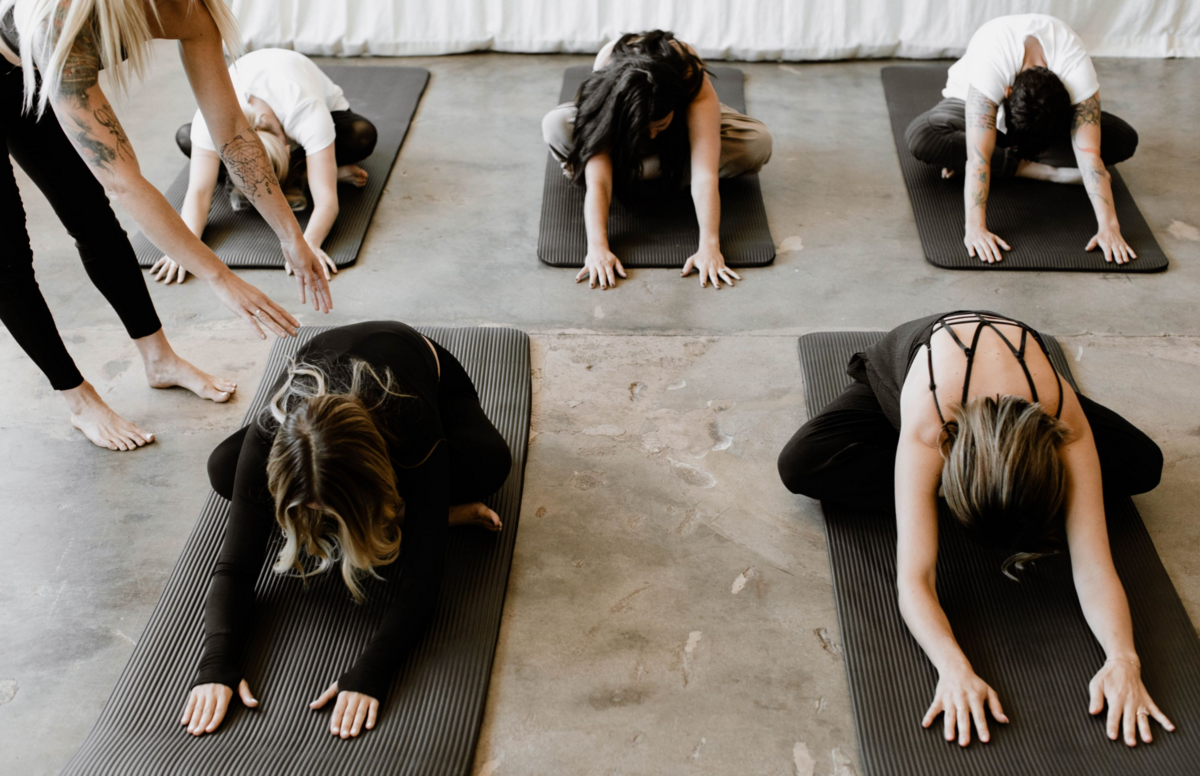 Peak Interactive Wellness clients in Denver and Greenwood Village practicing therapeutic yoga on mats, focusing on mindful movement and holistic mental health support.