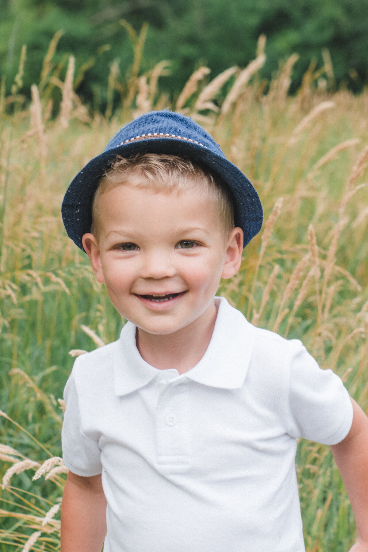 happy boy smiling in field