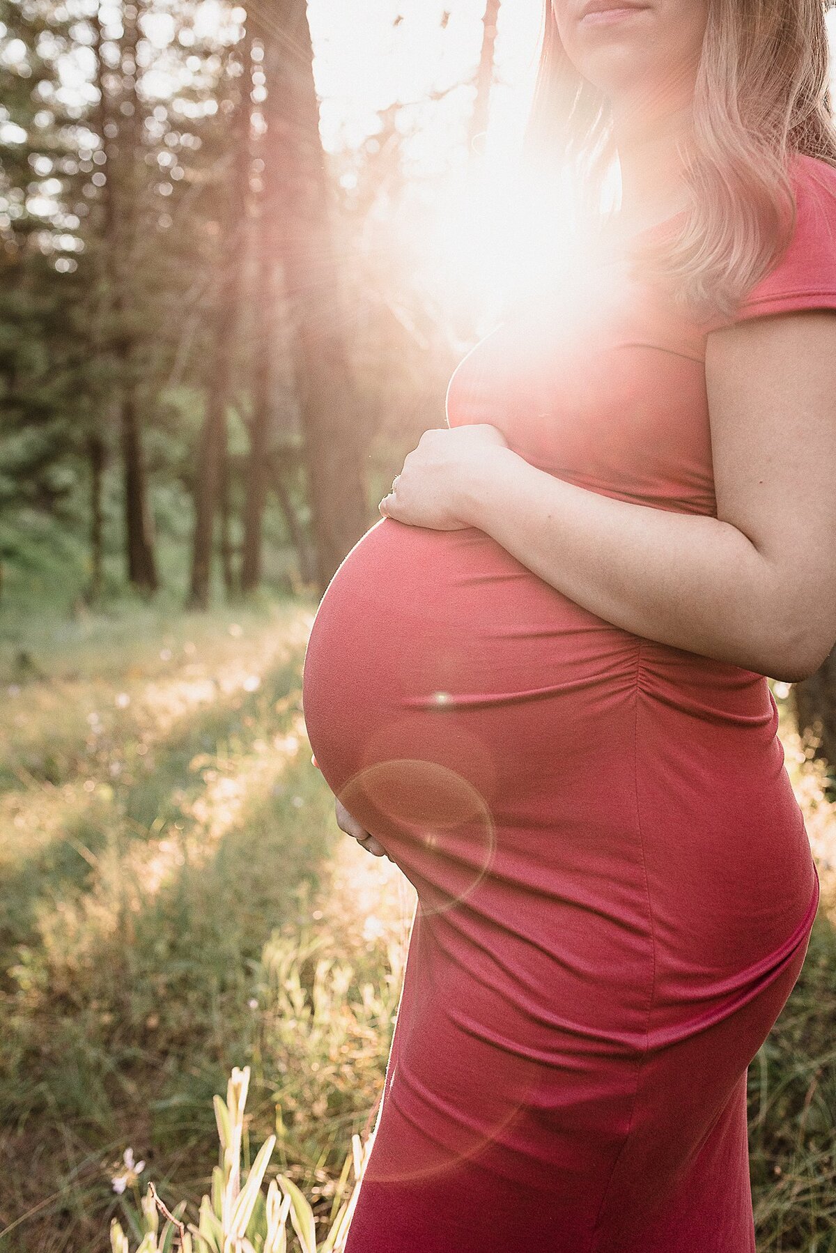 maternity belly pics with sun flare in Spokane, WA