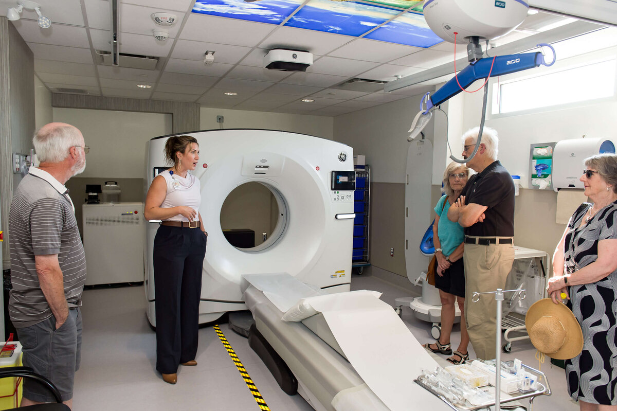 KDH female employee explains the workings of the CT Scanner to members of the public during the Grand Opening.  Captured by Ottawa Event Photographer JEMMAN Photography COMMERCIAL