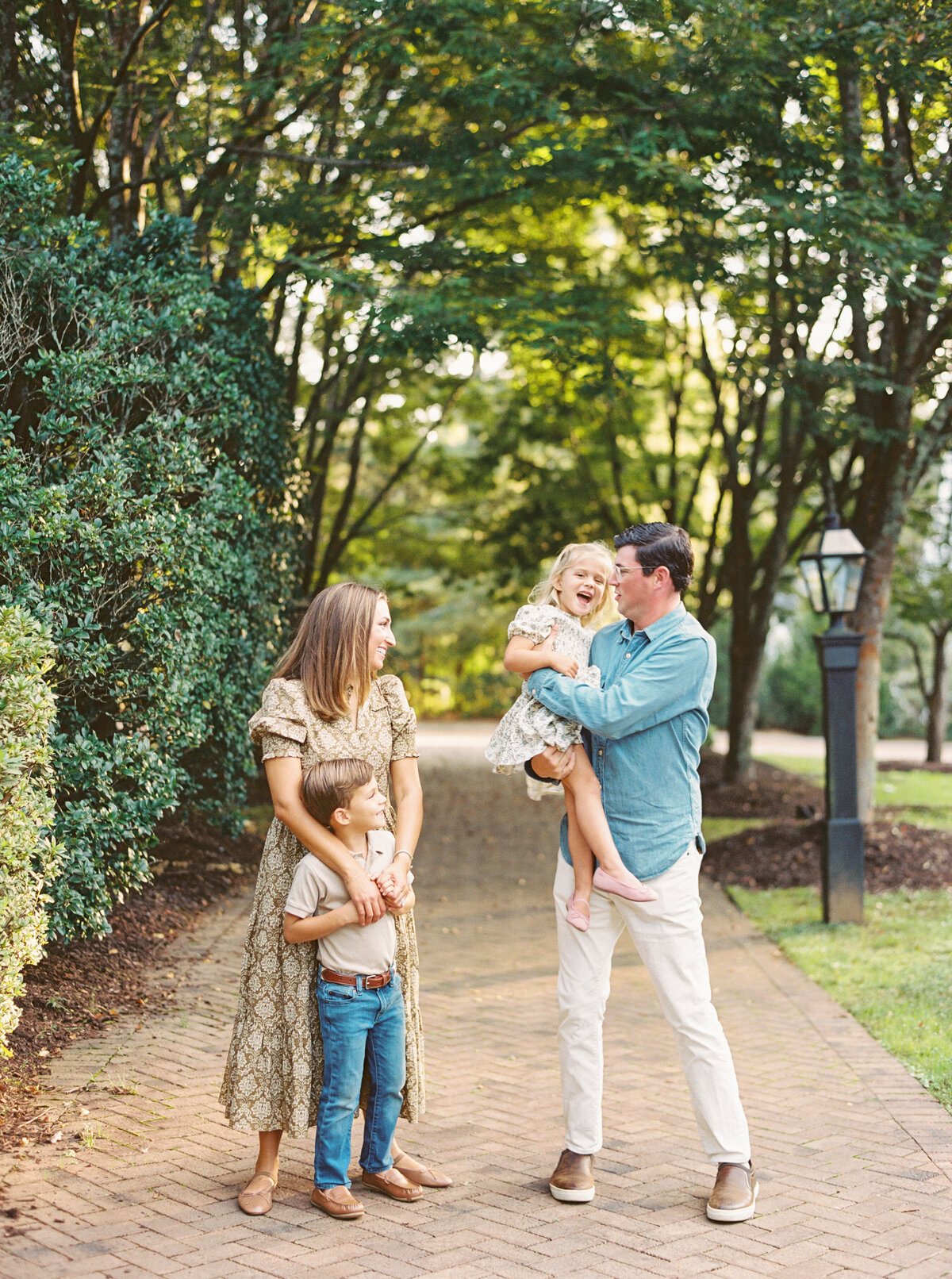 Parents play with their kids during a family session. Image by Raleigh maternity photographer A.J. Dunlap Photography.