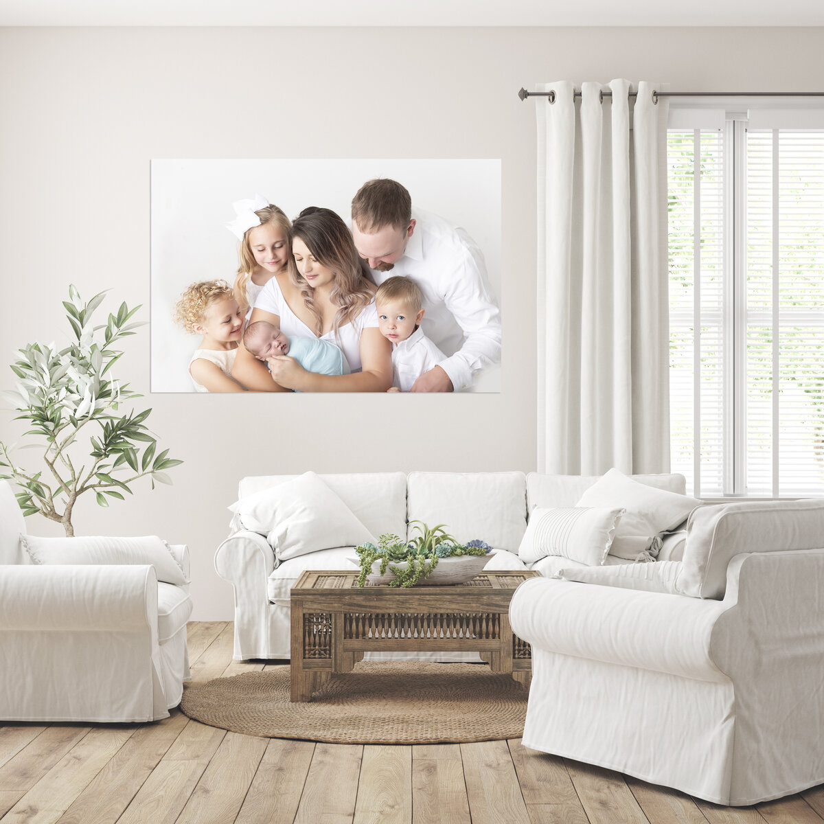 A framed family fine art photo hangs on a wall above a couch