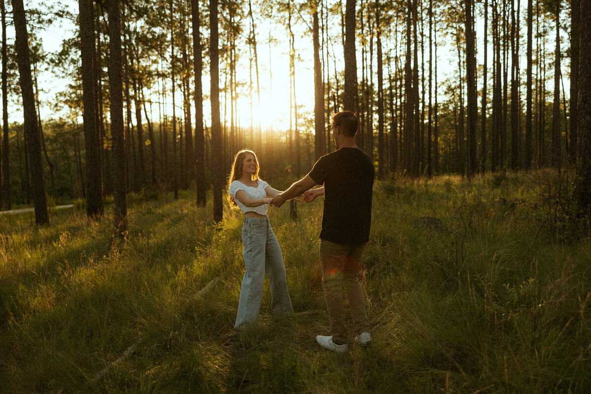 Couple posing for portraits in a forest.