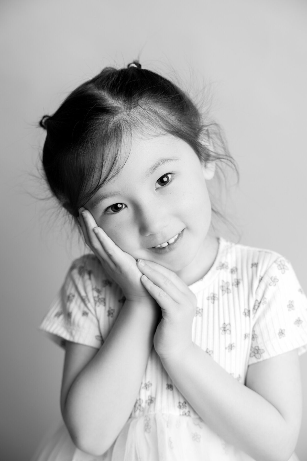 Black and white studio portrait of a little girl. 